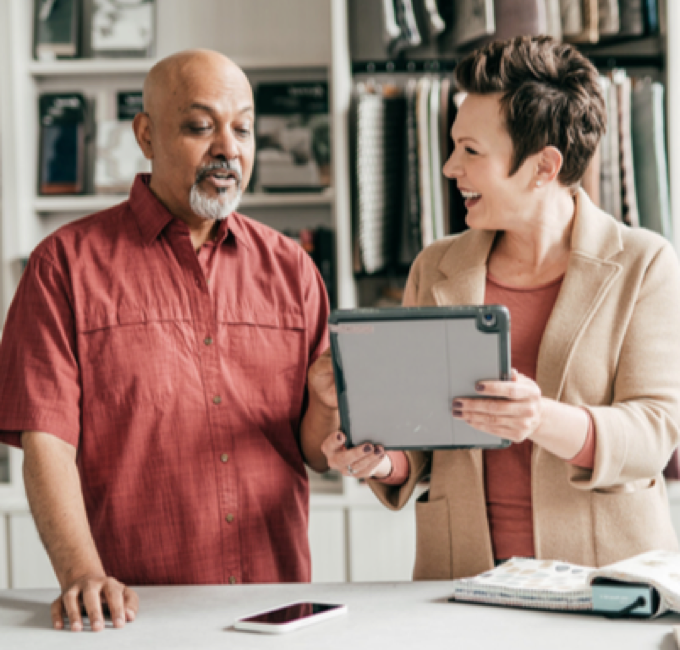 A man and a woman looking at a tablet